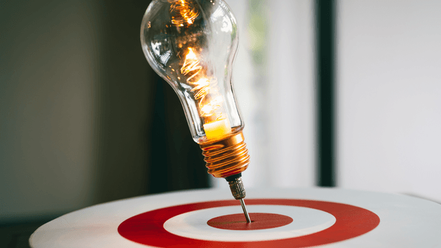 Lightbulb pinned to the center of a dartboard