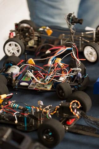 Set of three small robotic cars showing interior and wiring. 