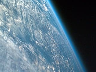Oblique shot of the Earth from space featuring its curvature and atmosphere.