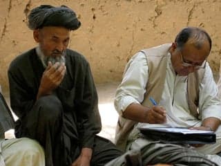 Photograph of men answering survey questions.