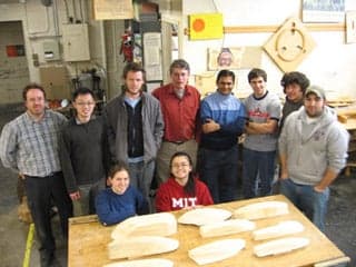 Instructors and students with their half-hull model boats.