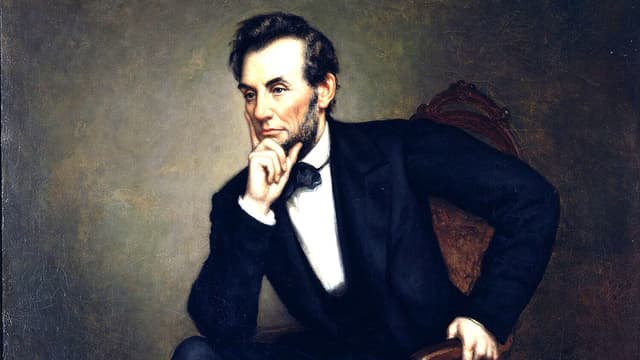 A painting of a seated, strong-faced, suit-wearing young man with his chin in his hand.