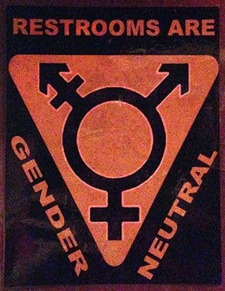 The words “Restrooms are gender neutral” surround a symbol featuring an “O” with an arrow and cross protruding from the top left, an arrow protruding from the top right, and a cross protruding from the bottom.