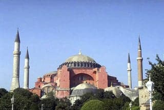 A large brick Byzantine cathedral, now a museum, with dome and four minarets.
