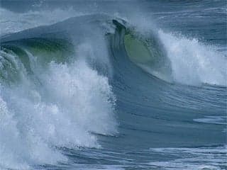 A photograph of an ocean wave cresting.