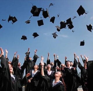 Students throwing graduation caps in the air.
