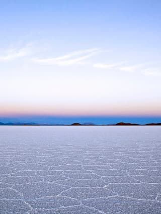 Sun beginning to rise over salt flats.